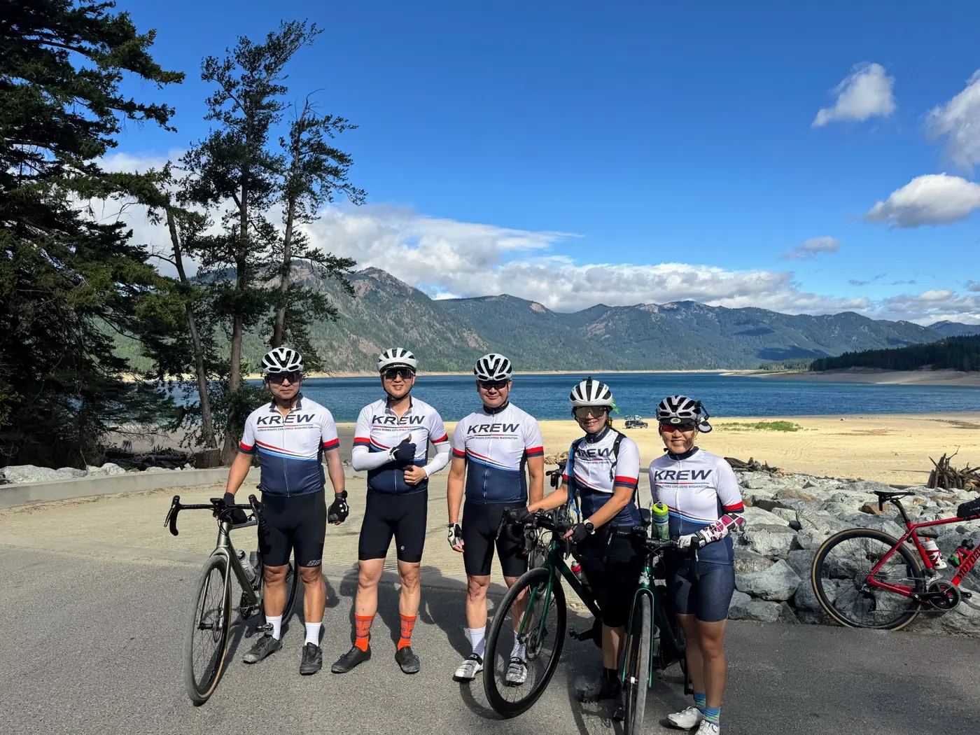 KREW cyclists together by a mountain lake in Washington