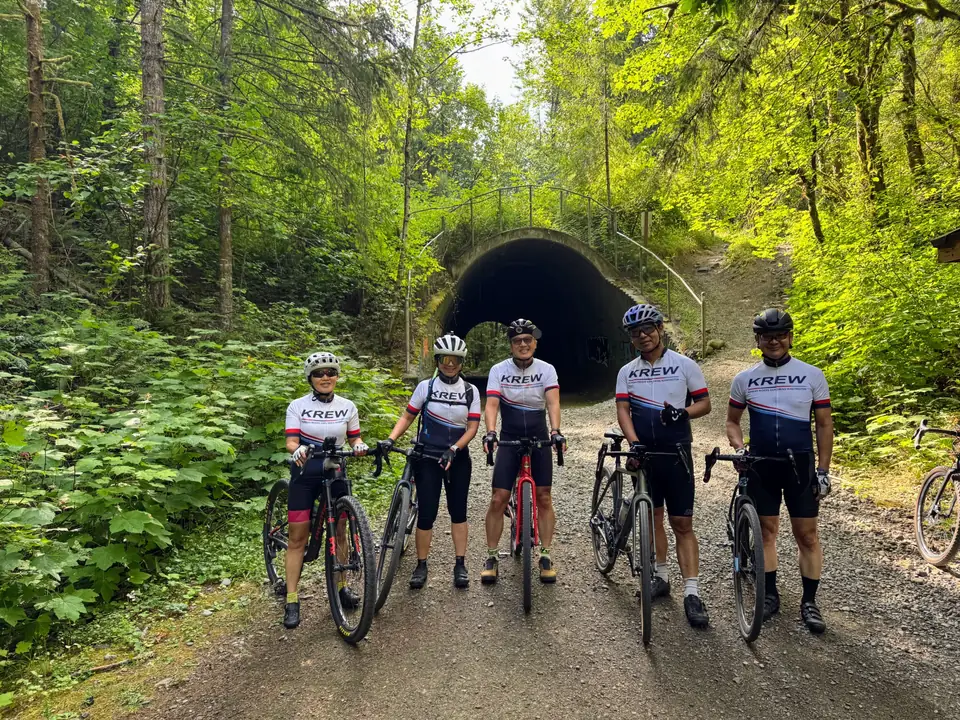 KREW riders gathered at a forest tunnel