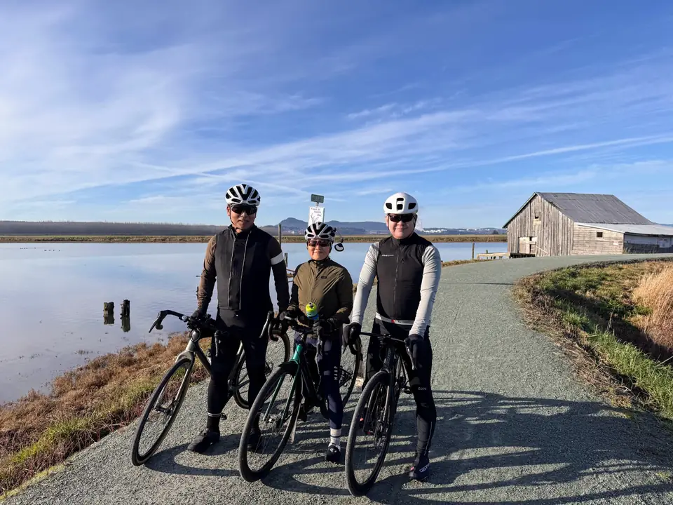 KREW riders beside a quiet waterfront trail